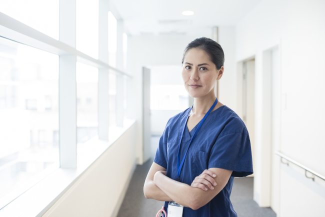 Photo of nurse standing in a hospital corridor